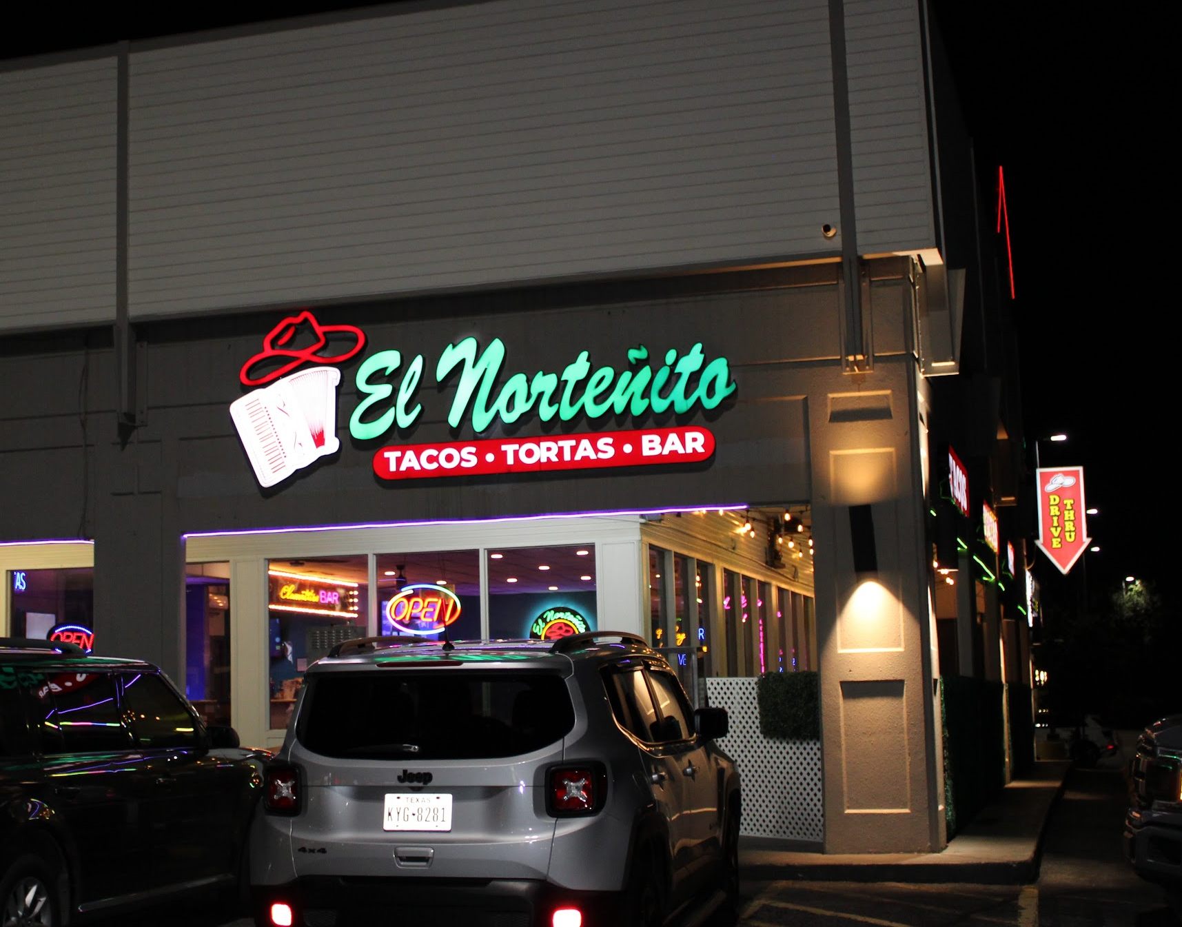 El Norteñito storefront at night with neon signage